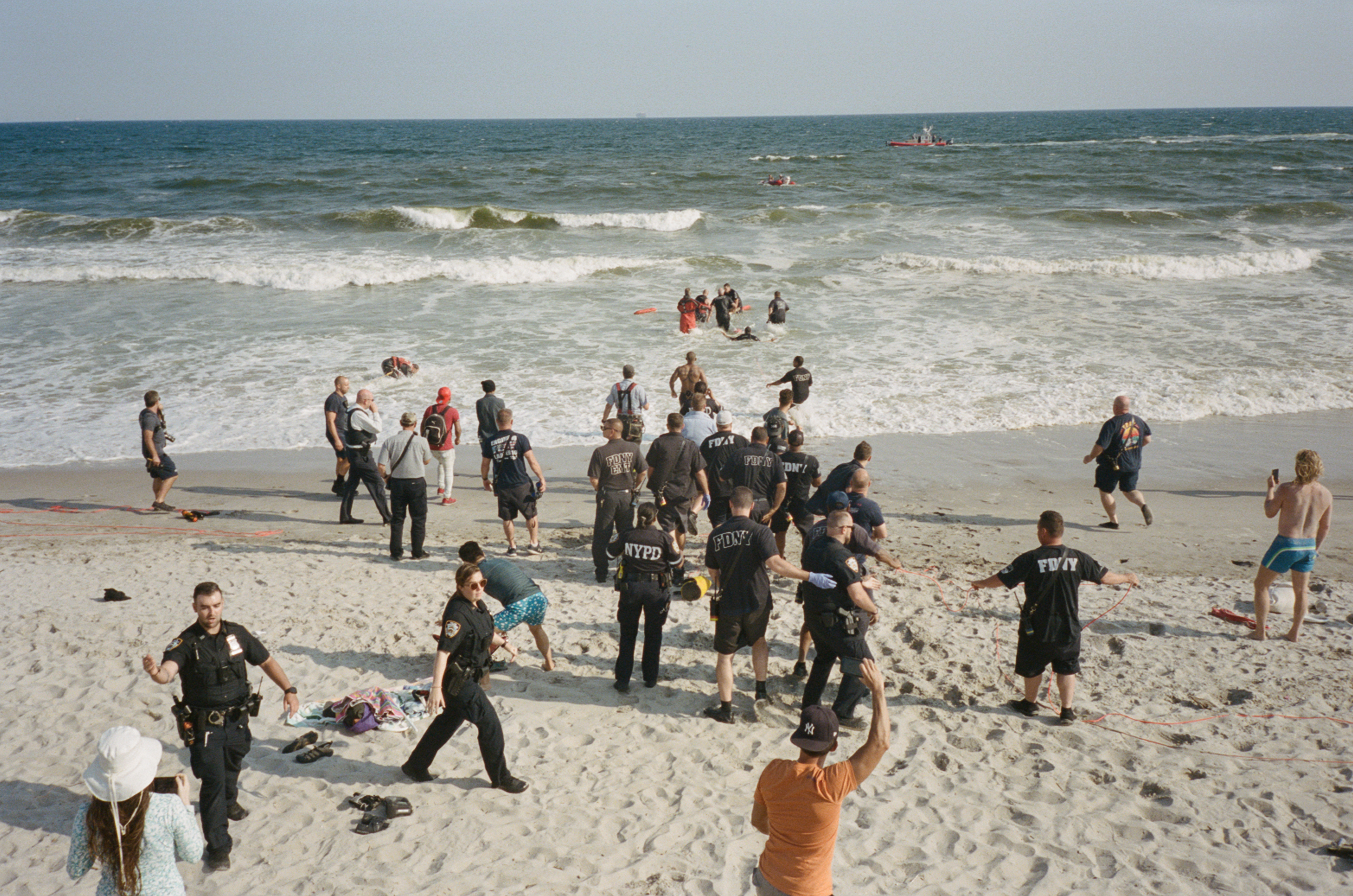 First responders rush to aid someone in the ocean.