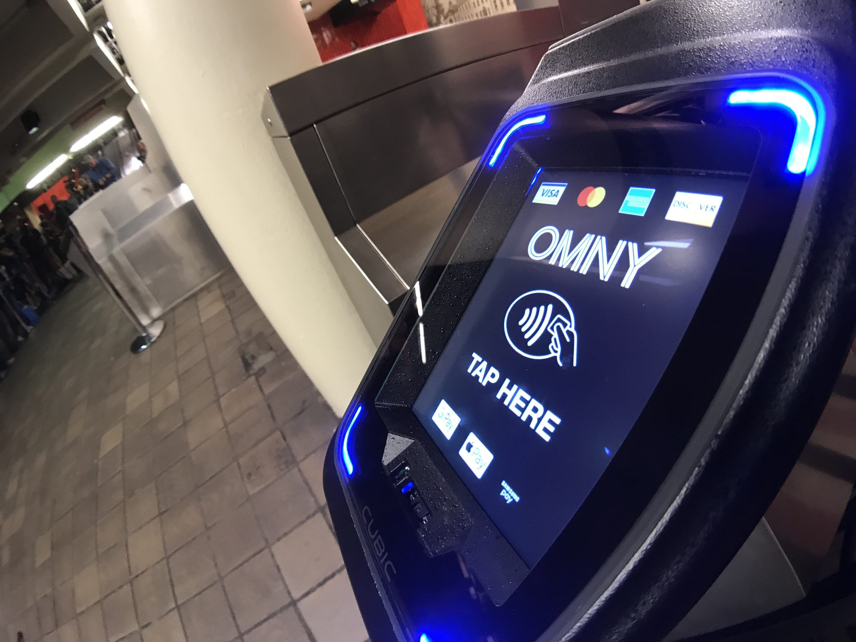 An OMNY reader at a subway turnstile.