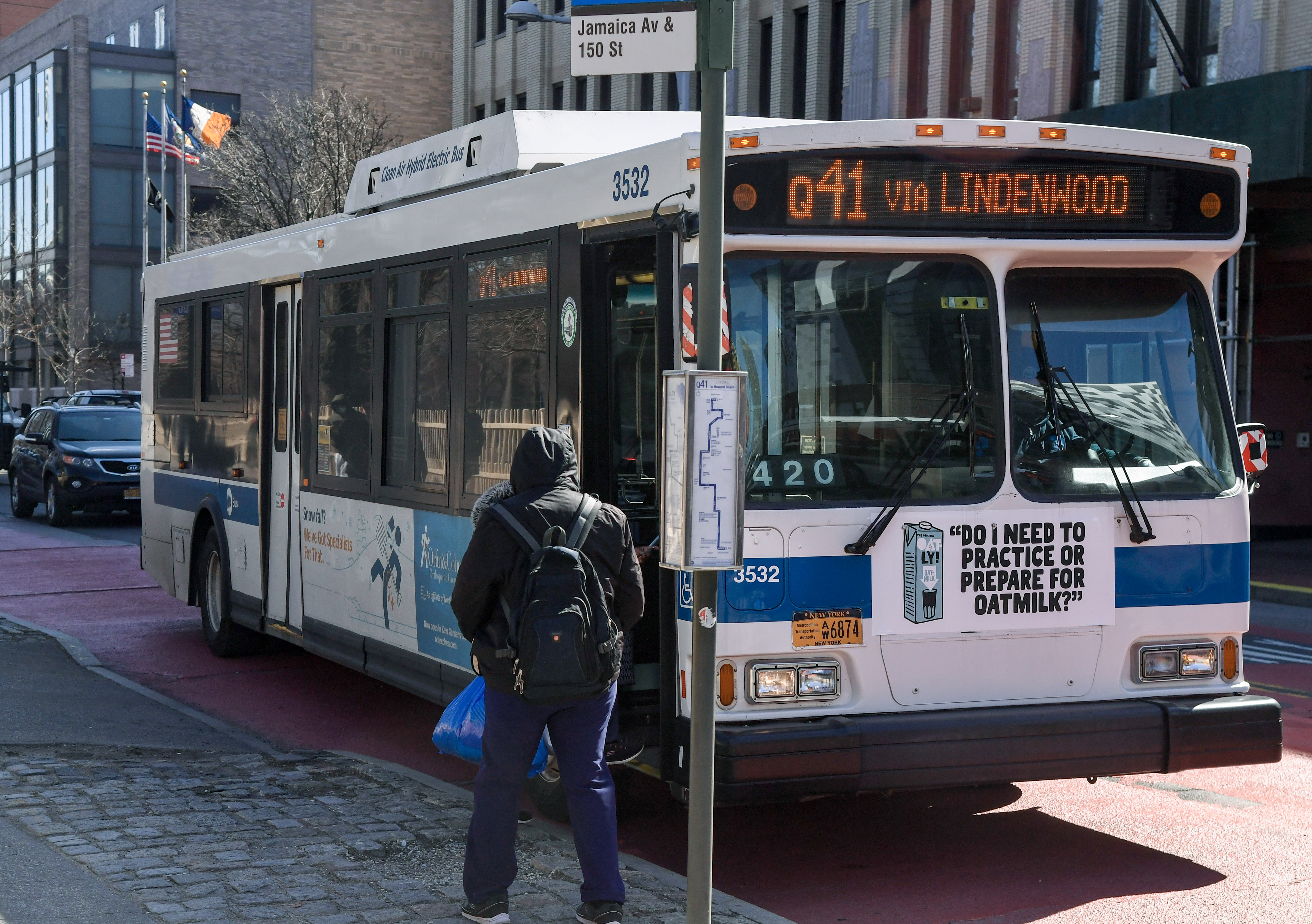 A passenger boards a New York City bus in Queens.