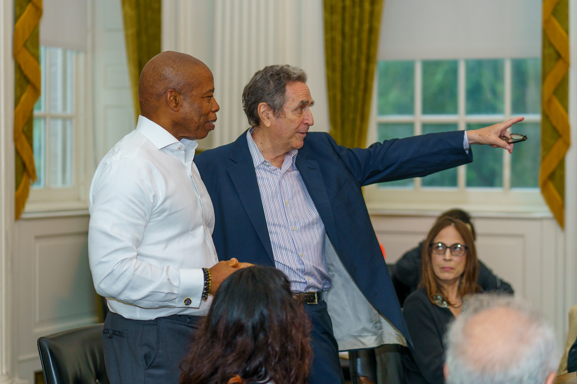 Civil liberties lawyer Norman Siegel stands and points with New York City mayor Eric Adams.`