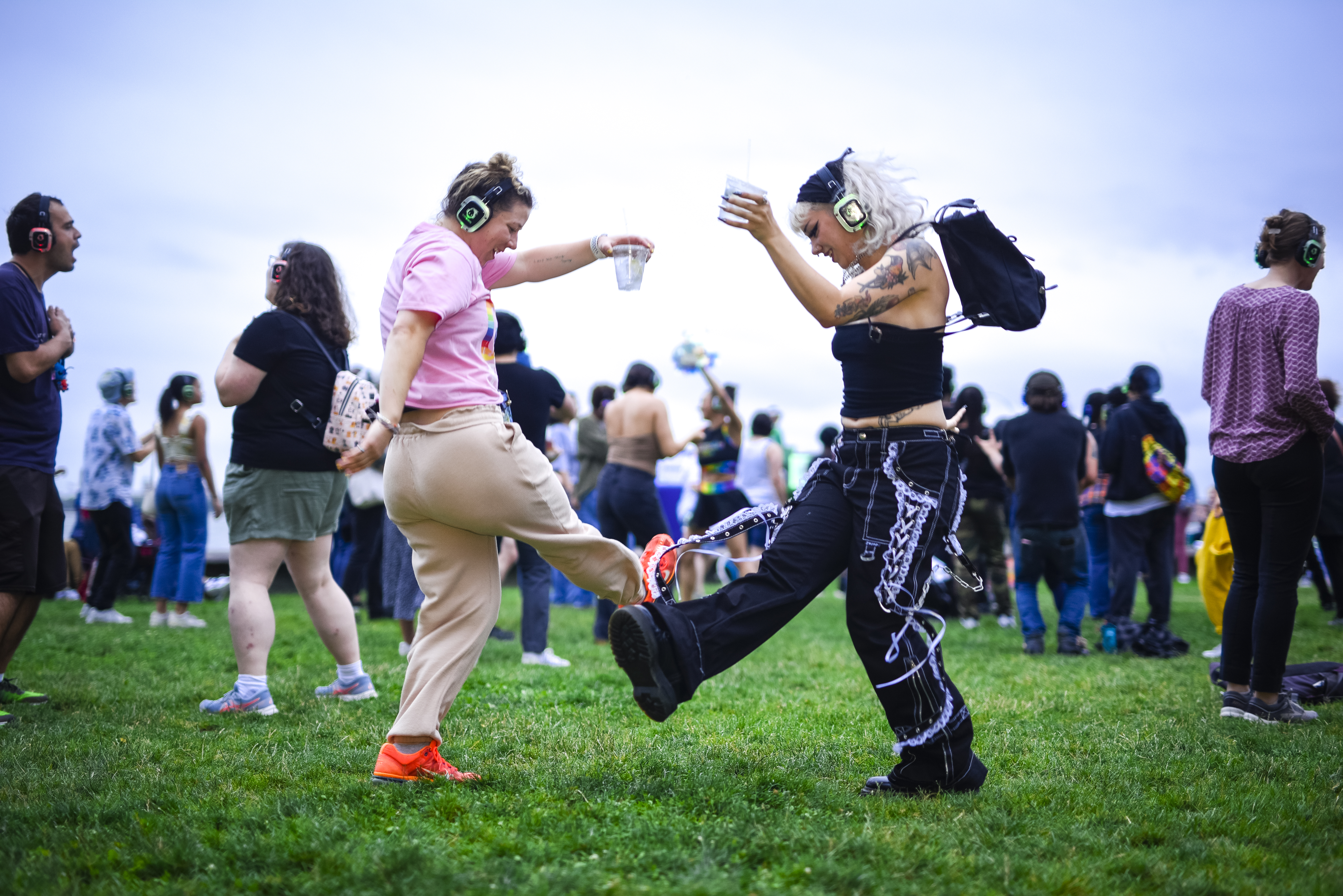 Two people wear headphones at a silent dance party