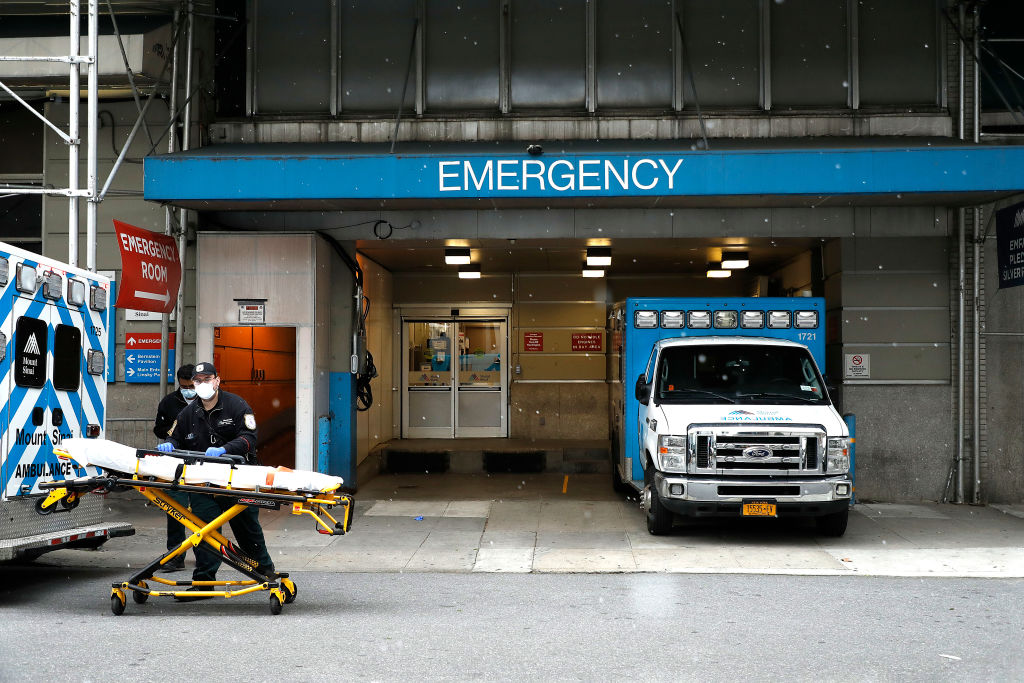 Emergency medical workers take a gurney out of an ambulance outside Beth Israel hospital in Gramercy Park in May 2020.