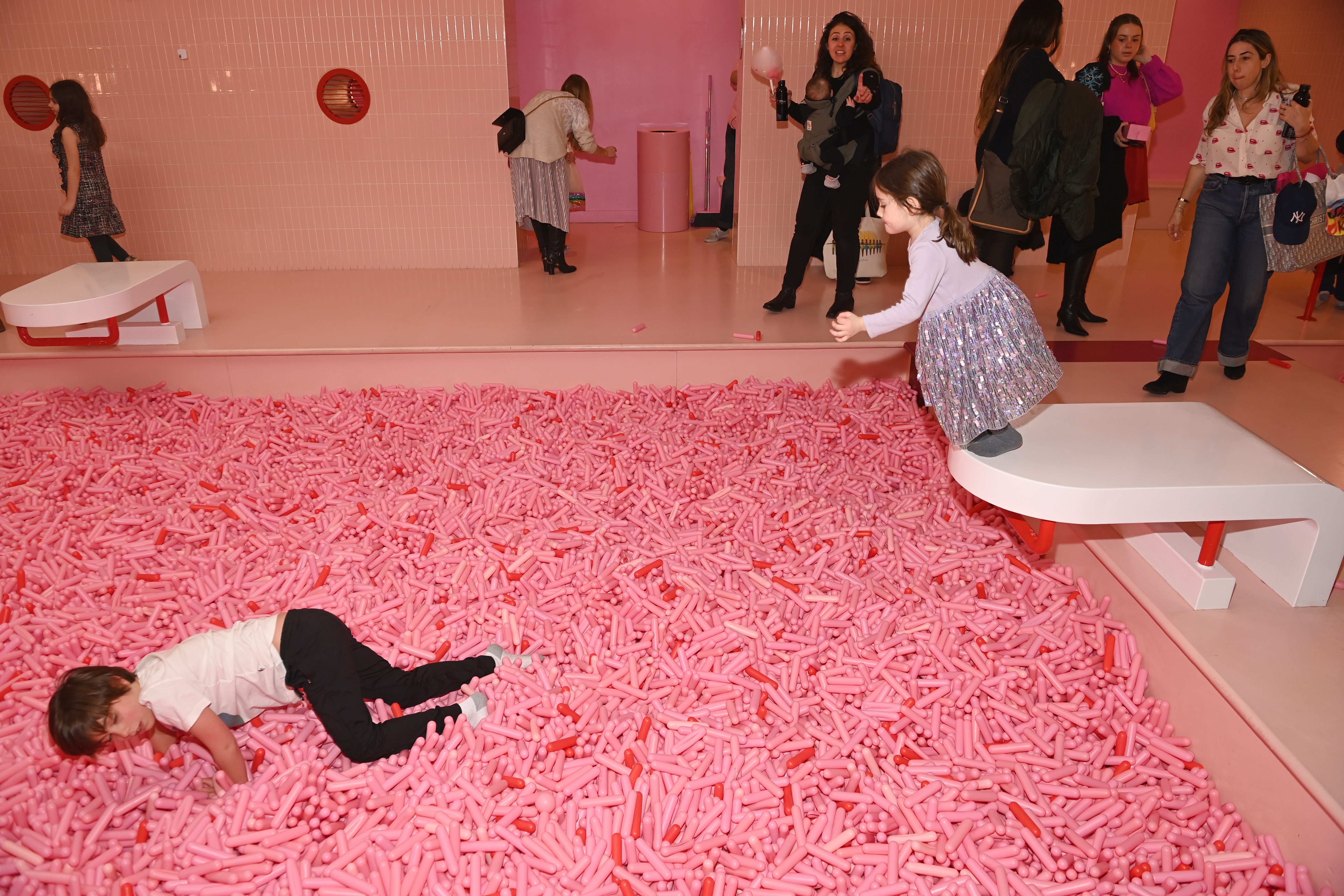 Children play in a pool made of faux-sprinkles.