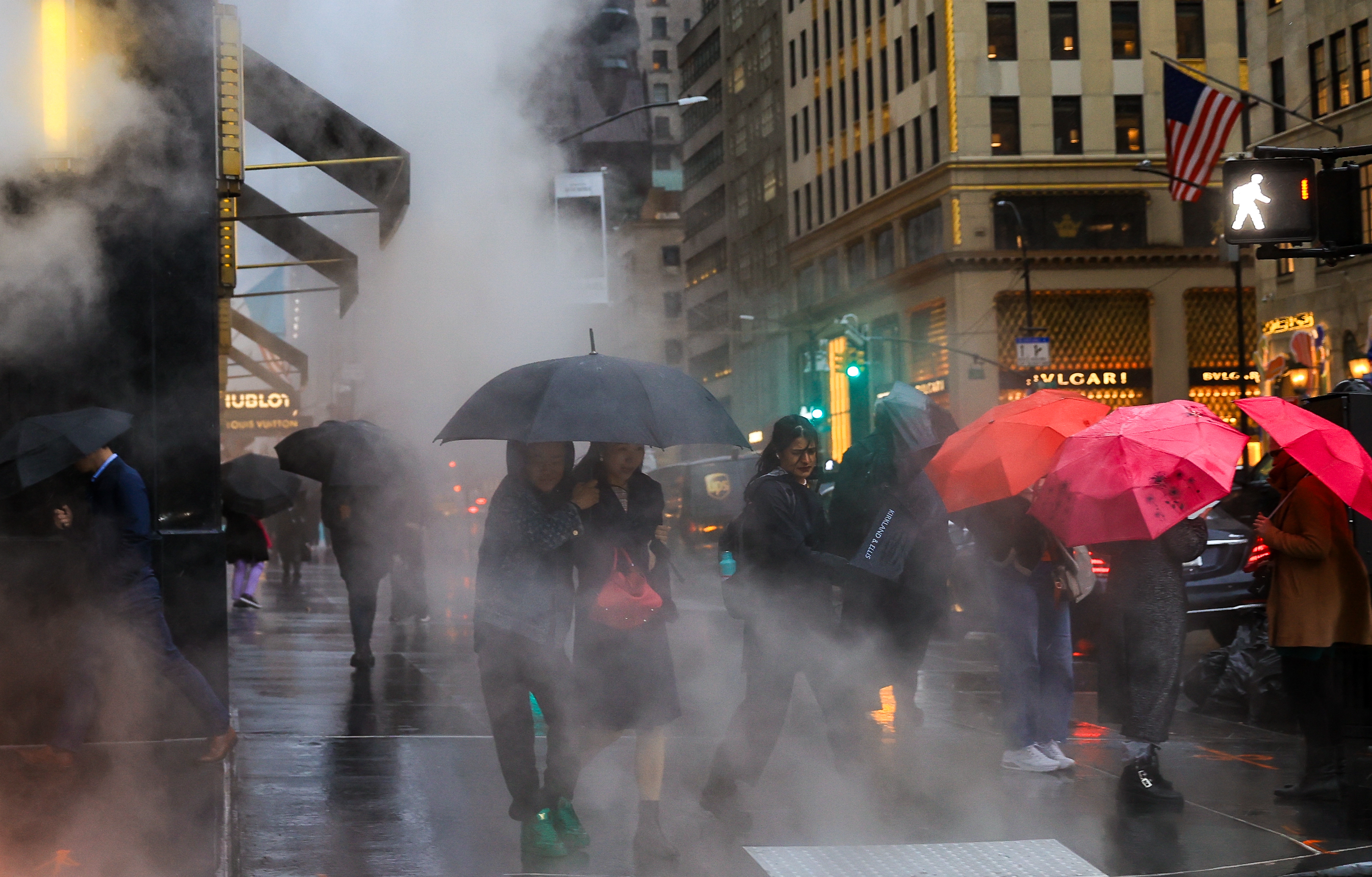 People walk in the heavy rain on a New York City street