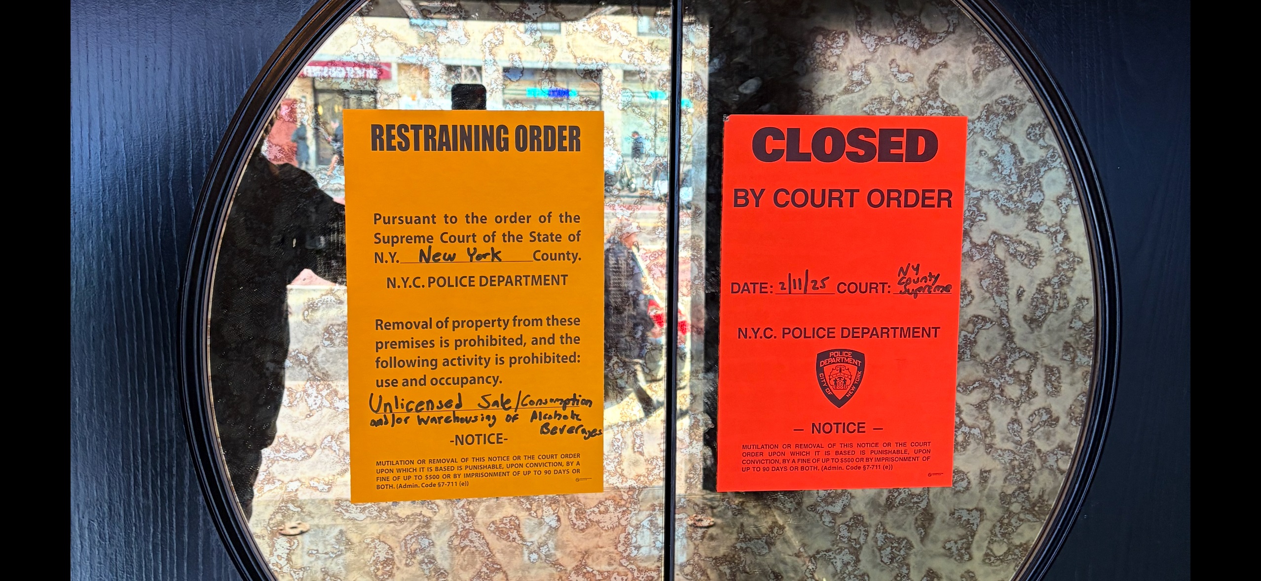 Closure orders are posted on the front doors of Baby's nightclub on March 18, 2025.