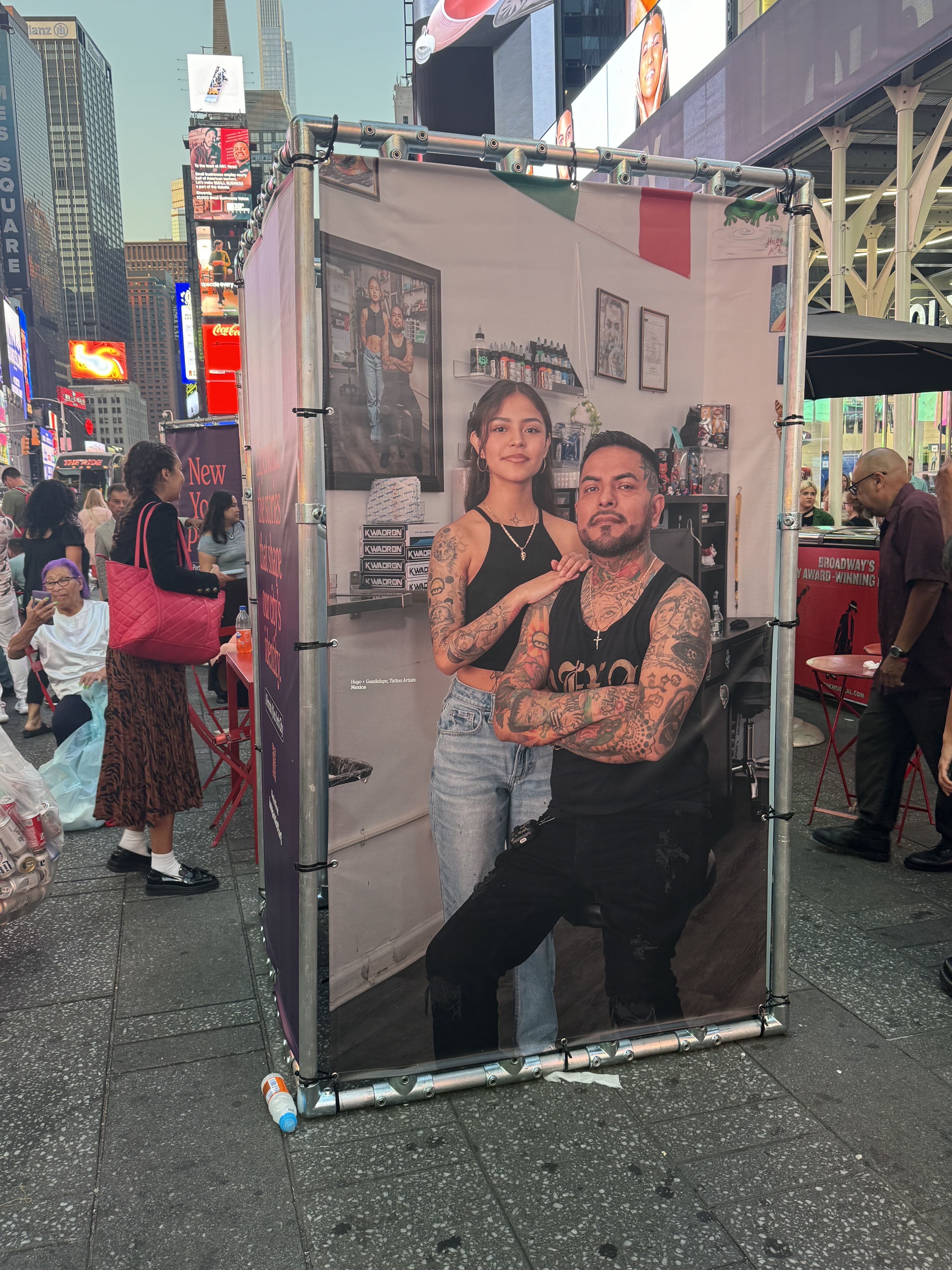 Portraits of immigrants by photographer Oscar B. Castillo, part of the New York Proud pop-up in Times Square. The work, being showcased across the city, aims to highlight the contributions of immigrants to the city's culture and economy.