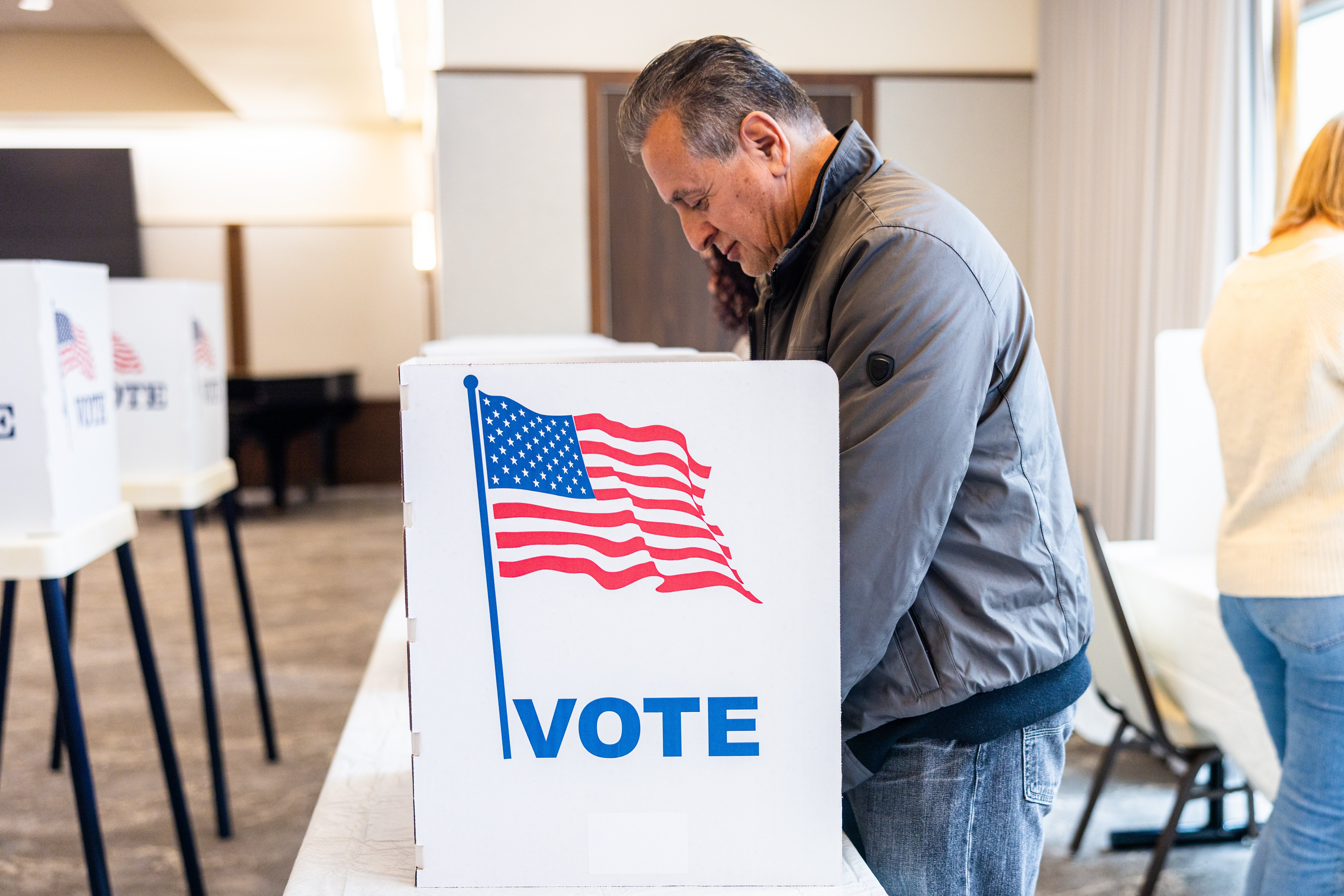 A stock image of someone voting.