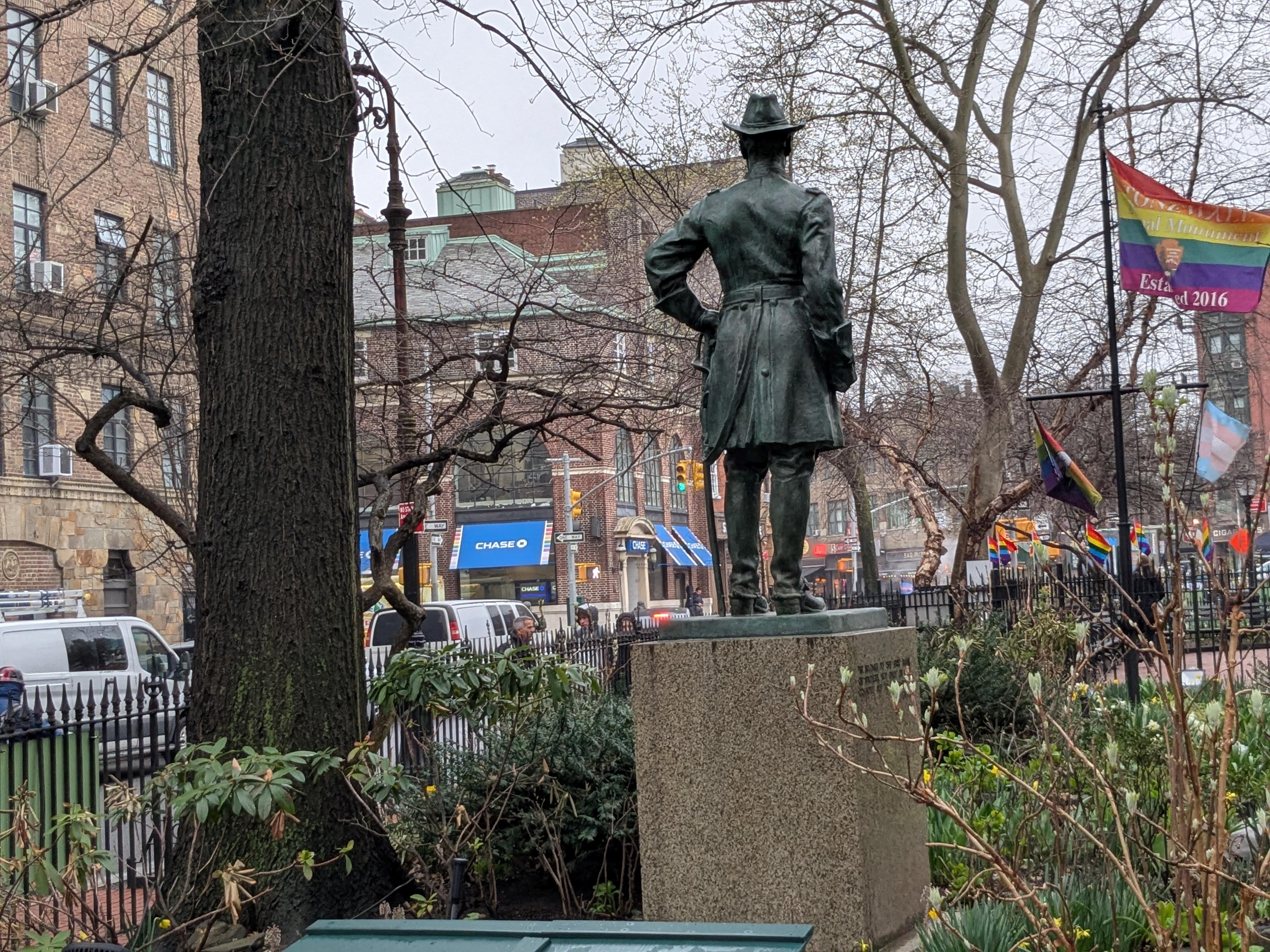 A statue of a man shot from behind.