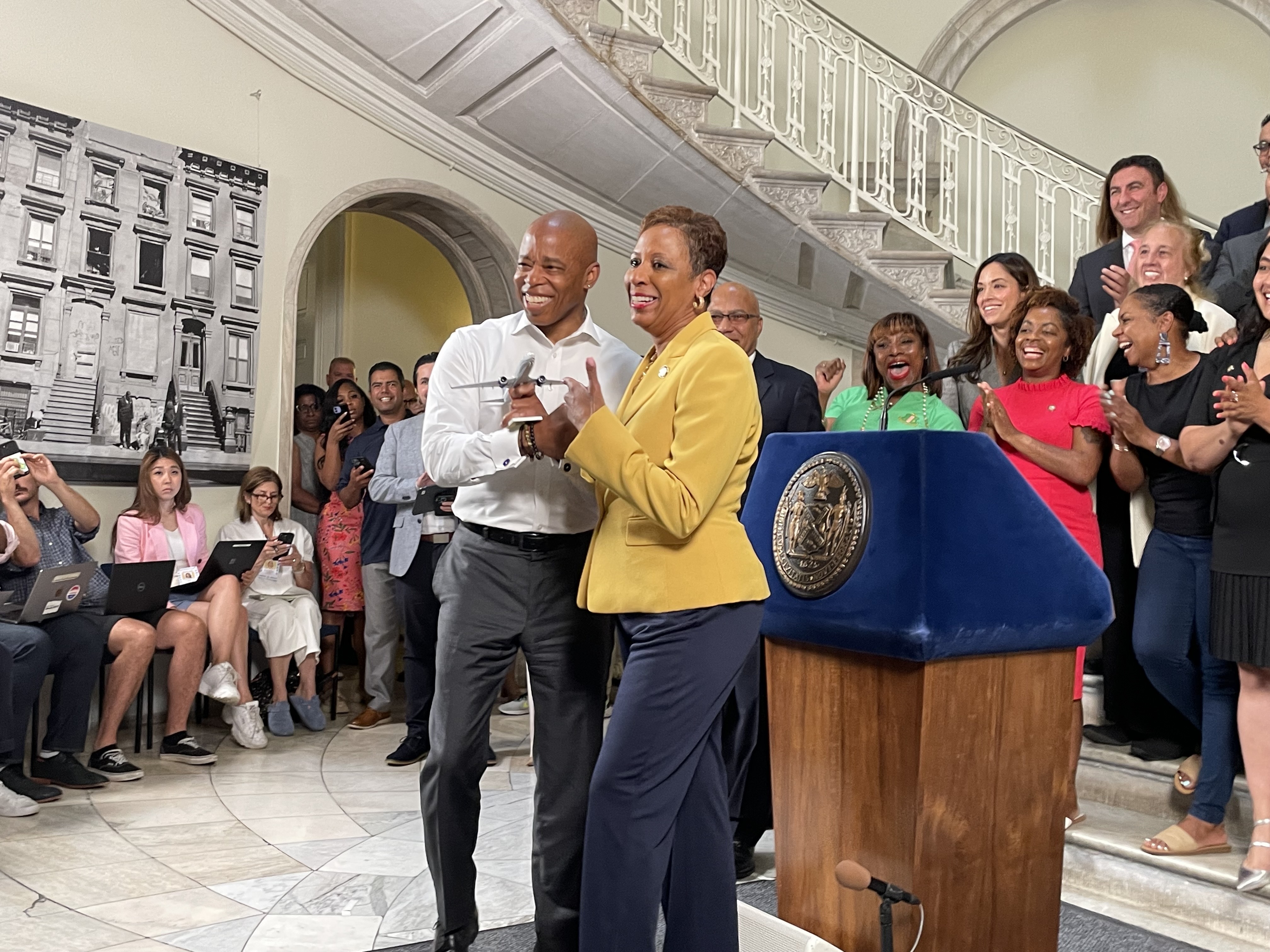 Mayor Eric Adams and City Council Speaker Adrienne Adams hold a toy plane at the press conference.
