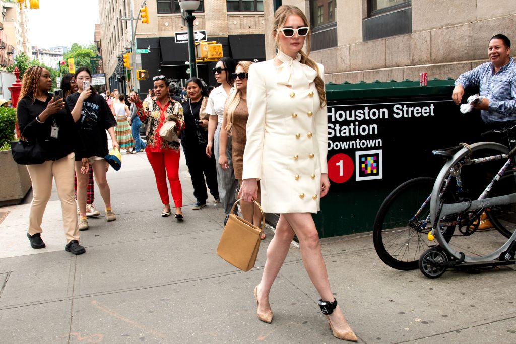 Anna Delvey walking in Hudson Square with her ankle monitor