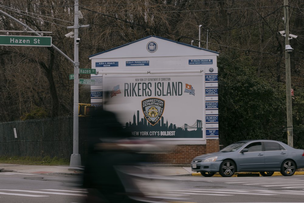 A sign reads "RIKERS ISLAND."