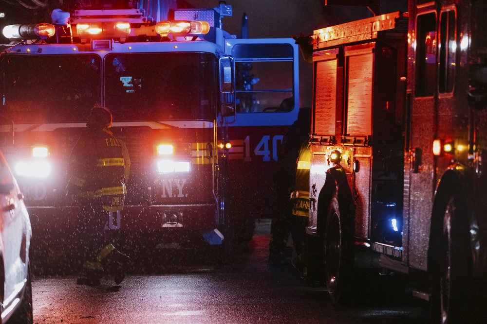 A photo of fire engines at night