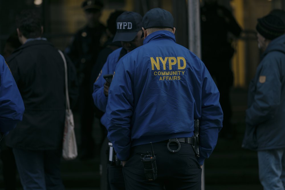An NYPD Community Affairs officer stands on a street in Staten Island on March 8, 2024.