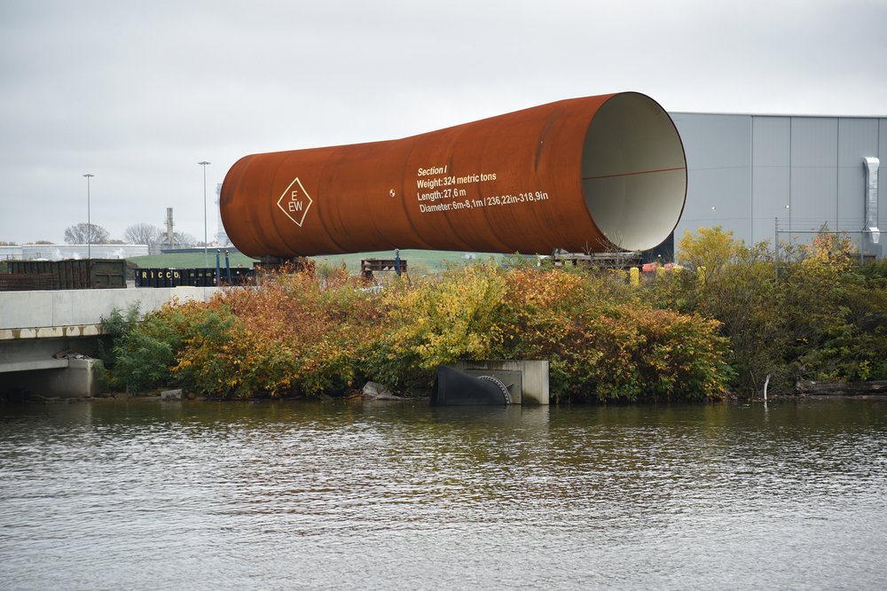 A section of an offshore wind monopile sitting on the banks of the Delaware River, at a new offshore wind manufacturing facility located at the Port of Paulsboro.