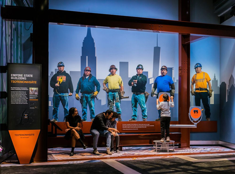 A portrait shot of several construction workers portraying ironworkers from several Native nations who've helped build Manhattan's famous skyscrapers.