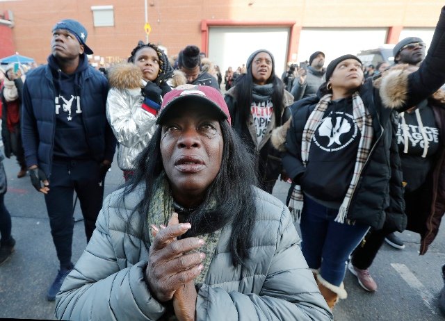 Bronx resident Catana Yehudah, 50, front, sheds tears as she hears the response of prisoners held inside the Metropolitan Detention Center. Yehudah's brother Jason Smith is currently serving 18 months inside MDC for gun possession. He has been incarcerated since June 2018. The prison has been without heat, hot water, electricity and flushing toilets for several days, including during the recent frigid cold.