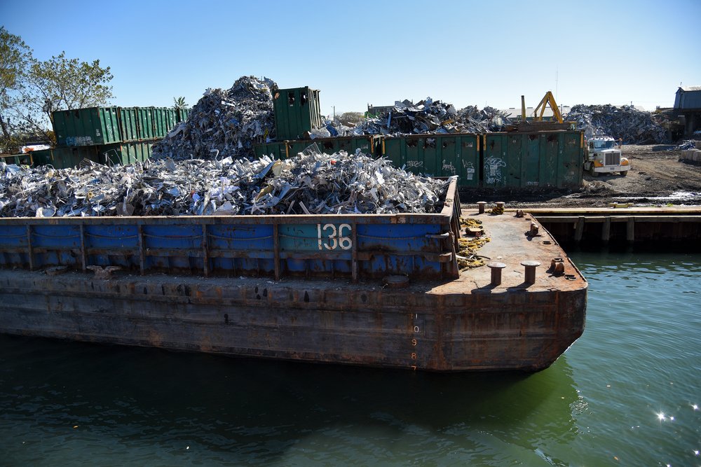 Newtown Creek is lined with active industrial businesses, including scrapyards, recycling centers, concrete plants and trucking facilities.