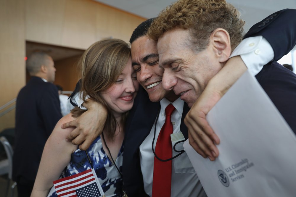 050978407gettyimages-831855556-jpg.jpeg Brazilian immigrant Gleidson Hoffman (C), celebrates after becoming an American citizen at a naturalization ceremony held in the One World Trade Center on August 15, 2017 in New York City<br>