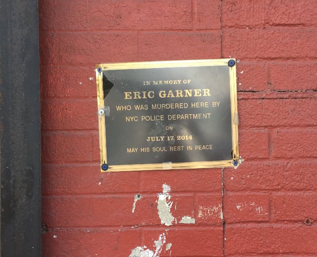A makeshift plaque marks the spot where Eric Garner was brought to the ground by Officer Daniel Pantaleo.