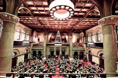 Members of the New York state Assembly work on passing legislation in the Assembly Chamber at the state Capitol, in Albany, N.Y