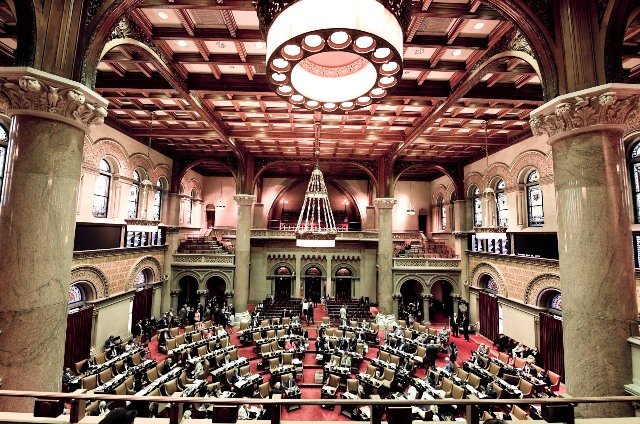 Members of the New York state Assembly work on passing legislation in the Assembly Chamber at the state Capitol, in Albany, N.Y