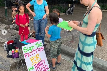 A Park Slope resident signs a petition supporting the opening of new homeless shelters in the neighborhood.