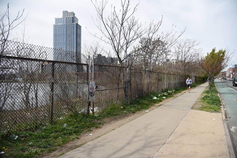 At Bushwick Inlet, the city-owned waterfront is inaccessible behind a fence lined with razor wire.