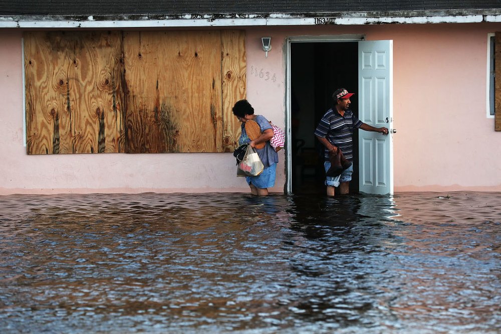 075529220gettyimages-845613802-jpg.jpeg A couple leave their flooded home the morning after Hurricane Irma swept through the area on September 11, 2017 in Fort Myers, Florida. (Getty)