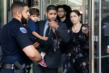 Juan Rodriguez leaves Bronx Criminal Court with his wife Marissa after a hearing today