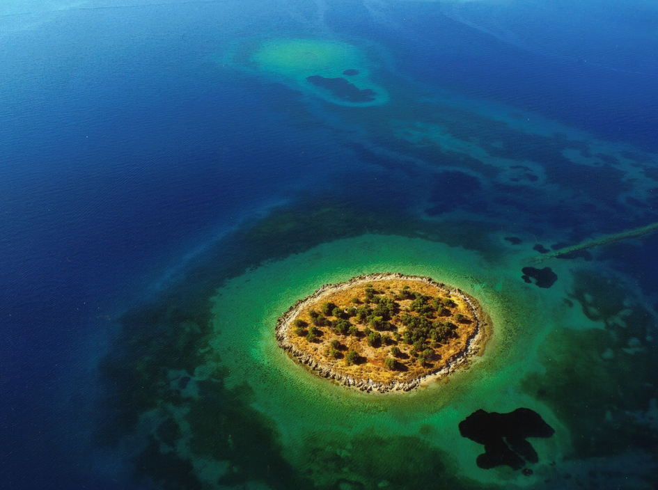 0baf0d7e7.jpeg St Athanasios Island. Cost: $1,857,215. Size: 2.5 Acres. Pros: "Pine and olive trees are scattered all over the ground...small sandy beach is located on the northwestern region of the island." Also, LOOK AT THAT PICTURE. Cons: SHUT UP & LOOK AT THAT PICTURE.