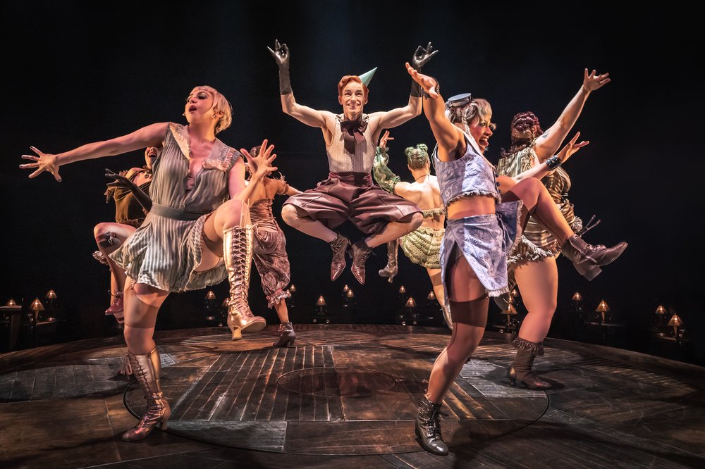 A group of performers dance on stage.
