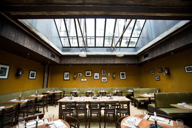 111909emporio.jpg Back in April, the team behind Aurora in Soho and Williamsburg branched out further with Emporio, the rustic Roman restaurant hewing toward a slightly lower price point than Aurora. Though it may be a little less expensive, it's no less charming, particularly the spacious back room with its vaulted skylights. But in the evening the front dining room and bar also draws an attractive crowd taking advantage of the complementary aperitivo menu (thin-crust wood-fired Roman-style pizza, cold cuts and fine cheeses), from 5-7 p.m., with the purchase of a cocktail. If you go, give the seasonal pumpkin martini a whirl; Emporio only has a beer and wine license, so their twist uses a house-made Soju, and the delicious cocktail tastes like a liquid pumpkin pie. Emporio also has a raw bar, home made pasta, and other traditional Roman entrees. On Monday nights they offer a Pizza Pie & 2 Beer special for $22.50, and late nights they serve a spuntino menu, featuring assorted pizzas, formaggi, salumi and crudo. The menu is offered seven days a week, from 11-2 a.m. on Monday through Thursday, from 12 a.m.-2 a.m. on Friday and Saturday, and from 10 p.m.-2 a.m. on Sunday. On Thanksgiving Emporio will serve a prix fixe Thanksgiving Day Menu for $45. Options include a Butternut Kabocha squash soup with caramelized pear and pecorino cheese, Setaro mezzi rigatoni with oxtail ragu and fiore Sardo, and a roasted free-range turkey with pork and apple stuffing and cranberry sauce. For dessert, there will be a pumpkin and ricotta tart served with pumpkin ice cream and maple syrup will satisfy your sweet tooth. 231 Mott St (between Prince and Spring), (212) 966-1234