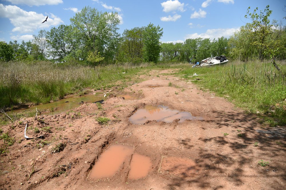 The dirt roads at the proposed site of the Arthur Kill Terminal are frequently flooded and pass through woodlands, meadows and wetlands.