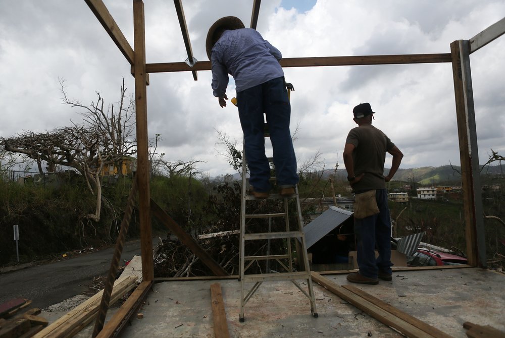 1607be318gettyimages-860365004-jpg.jpeg Men work repairing a partially destroyed bar three weeks after Hurricane Maria hit the island, on October 11, 2017 in Aibonito, Puerto Rico. <br/>