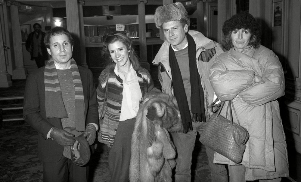 1c39c244ashutterstock_7543605d-jpg.jpeg At the Theatre On Shaftesbury Avenue. Paul Simon Carrie Fisher Art Garfunkel and Penny Marshall, 1982.<br/>