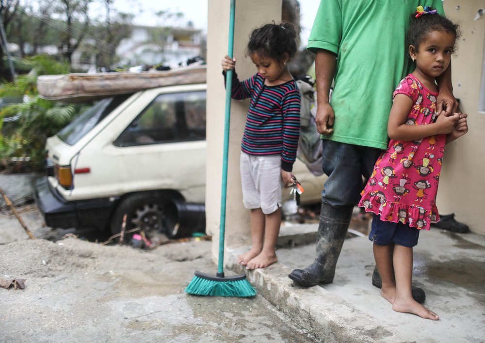 1d18f5156gettyimages-859565528-jpg.jpeg Young members of the Timoral family stand in front of their damaged home, with no running water or electricity, more than two weeks after Hurricane Maria hit the island, on October 9, 2017 in Jayuya, Puerto Rico. <br/>