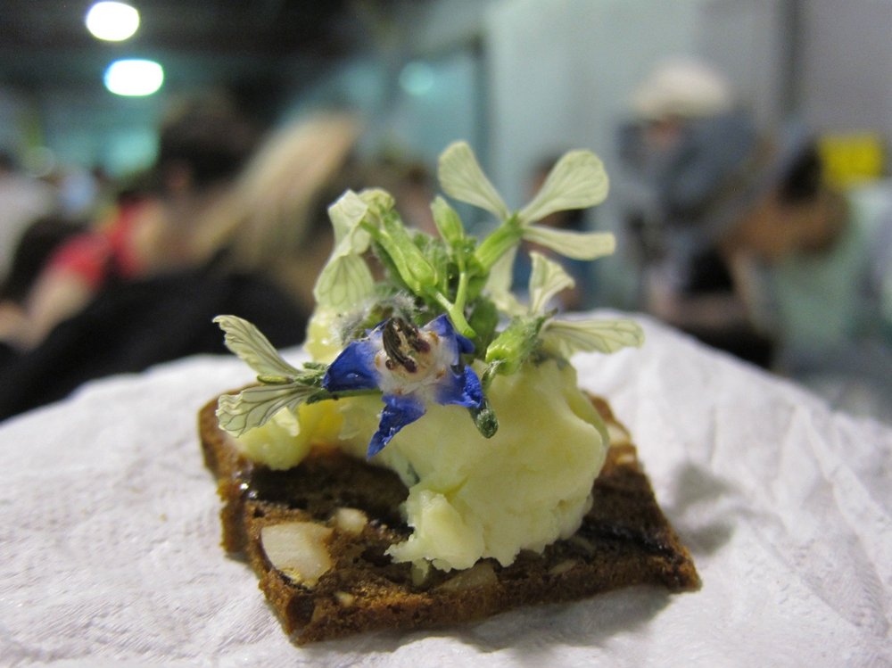 1f6f47c12.jpeg "Handmade Hazelnut Cracker topped with Chiriboga Blue, Rhododendron Honey, and Edible Flowers," from Halley Zellcoff, Whole Foods Gowanus<br>