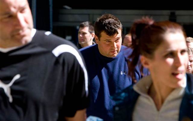 Federal agents escort Tommy Orefice, center, a reputed member of the Gambino organized crime family, from Federal Plaza