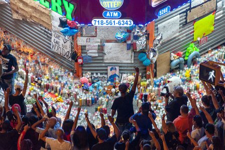 Photograph of a vigil outside the bodega where Lesandro "Junior" Guzman-Feliz was killed.