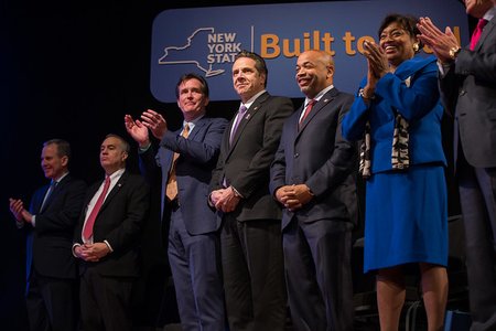 Cuomo in 2016 standing alongside Carl Heastie, right, and Andrea Stewart-Cousins.