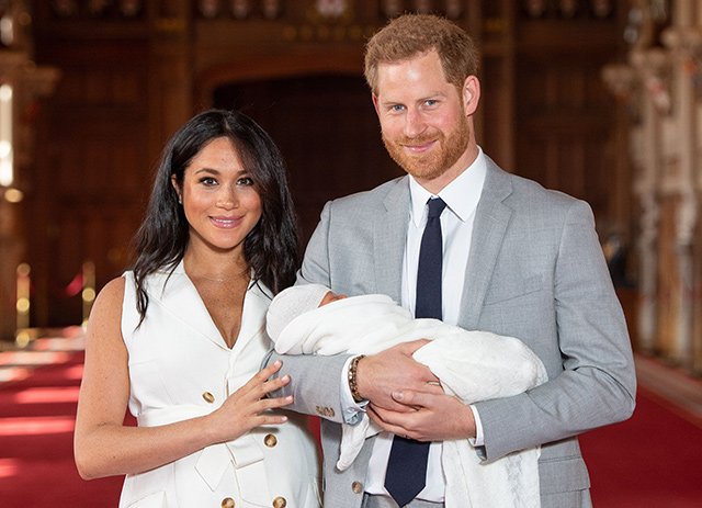 Prince Harry and Meghan Duchess of Sussex with their baby son Archie Harrison Mountbatten-Windsor during a photocall in St George's Hall at Windsor Castle in Berkshire