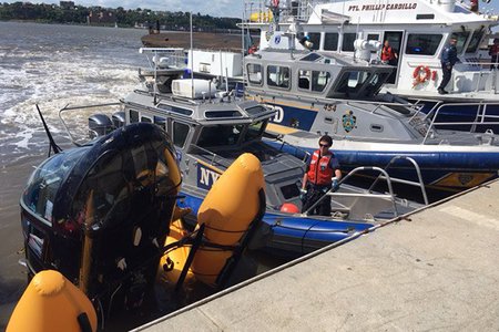 NYPD bring in a helicopter that crashed near Hudson River Park on May 15, 2019.