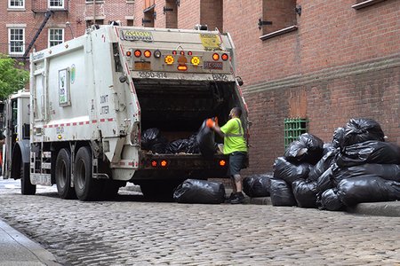A sanitation worker with truck