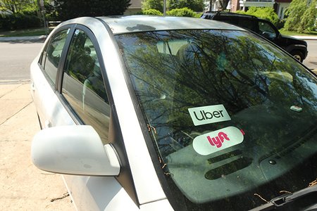A car with both Uber and Lyft stickers
