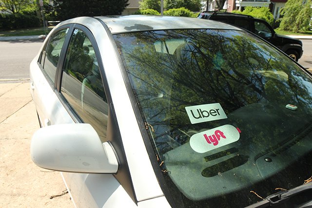 A car with both Uber and Lyft stickers