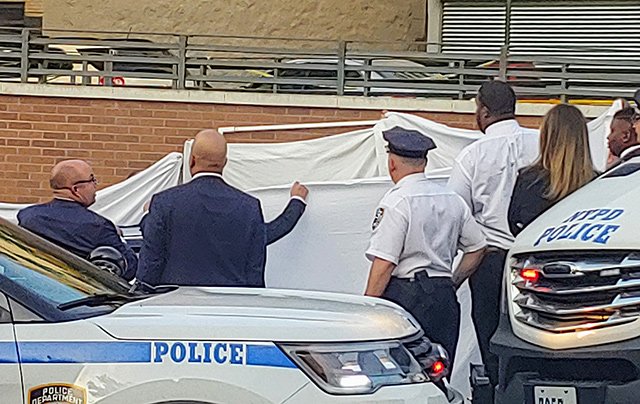 Police surround the car on West Kingsbridge Road