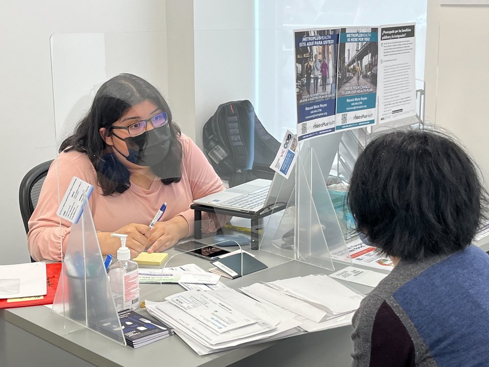 Benefit Access Specialist Jennifer Pereda talks to Blanca Lopez about getting recertified for SNAP at the Hunger Free America office in the Bronx.