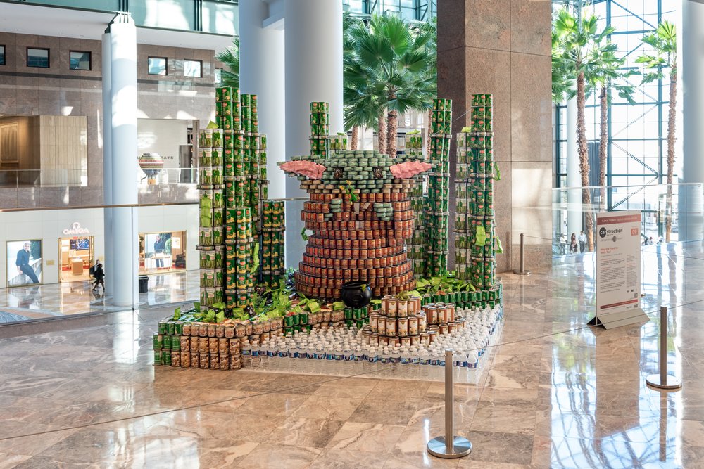 Cans arranged to form a statue.