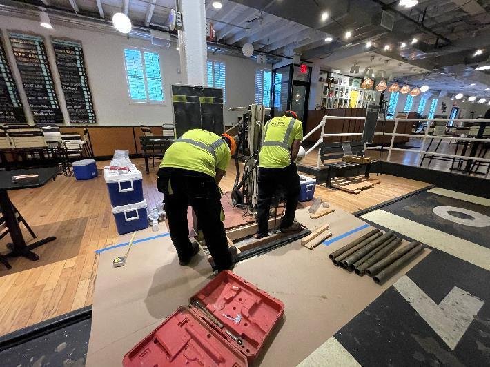 Contractors install a groundwater monitoring well inside 514 Union Street in Brooklyn. The well was used to investigate the site's subterranean levels of industrial chemicals. Photo from DEC daily field report, Sept. 6, 2022