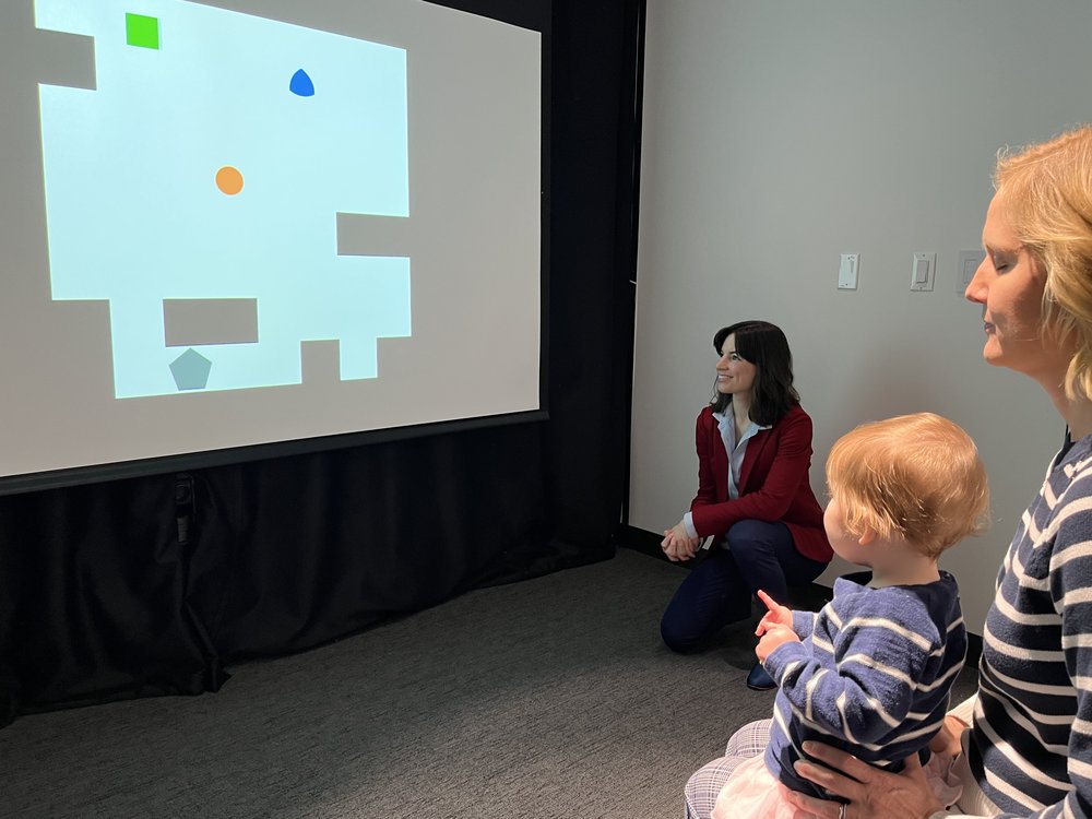 An infant in the lab sees the preliminary stimuli for planned tasks probing infant and machine recognition of potential social partners, another component of their commonsense psychology.